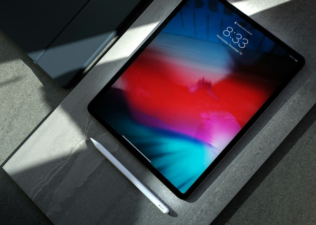 Tablet with a colourful screen on a dark surface