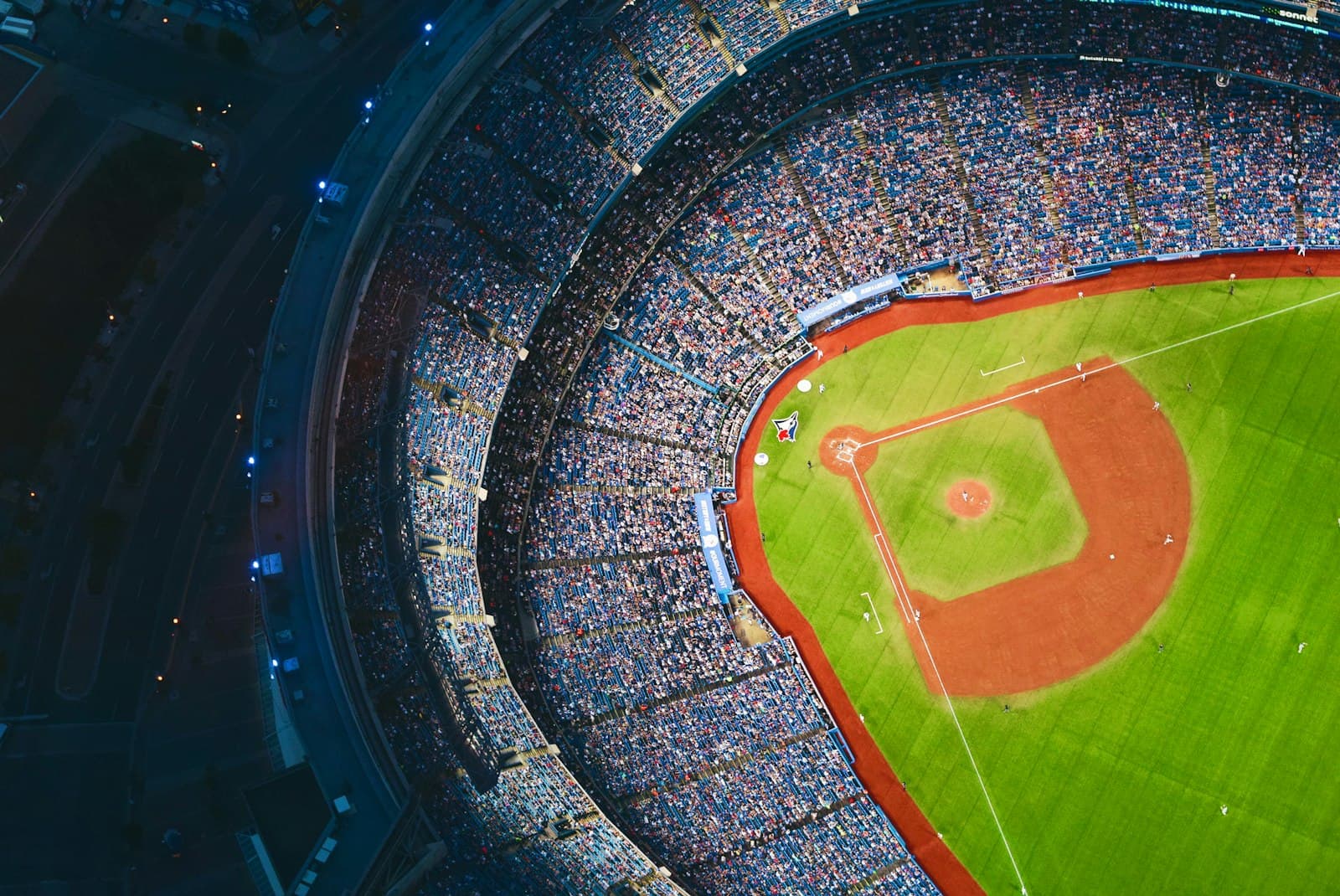 Aerial view of a packed baseball stadium under lights