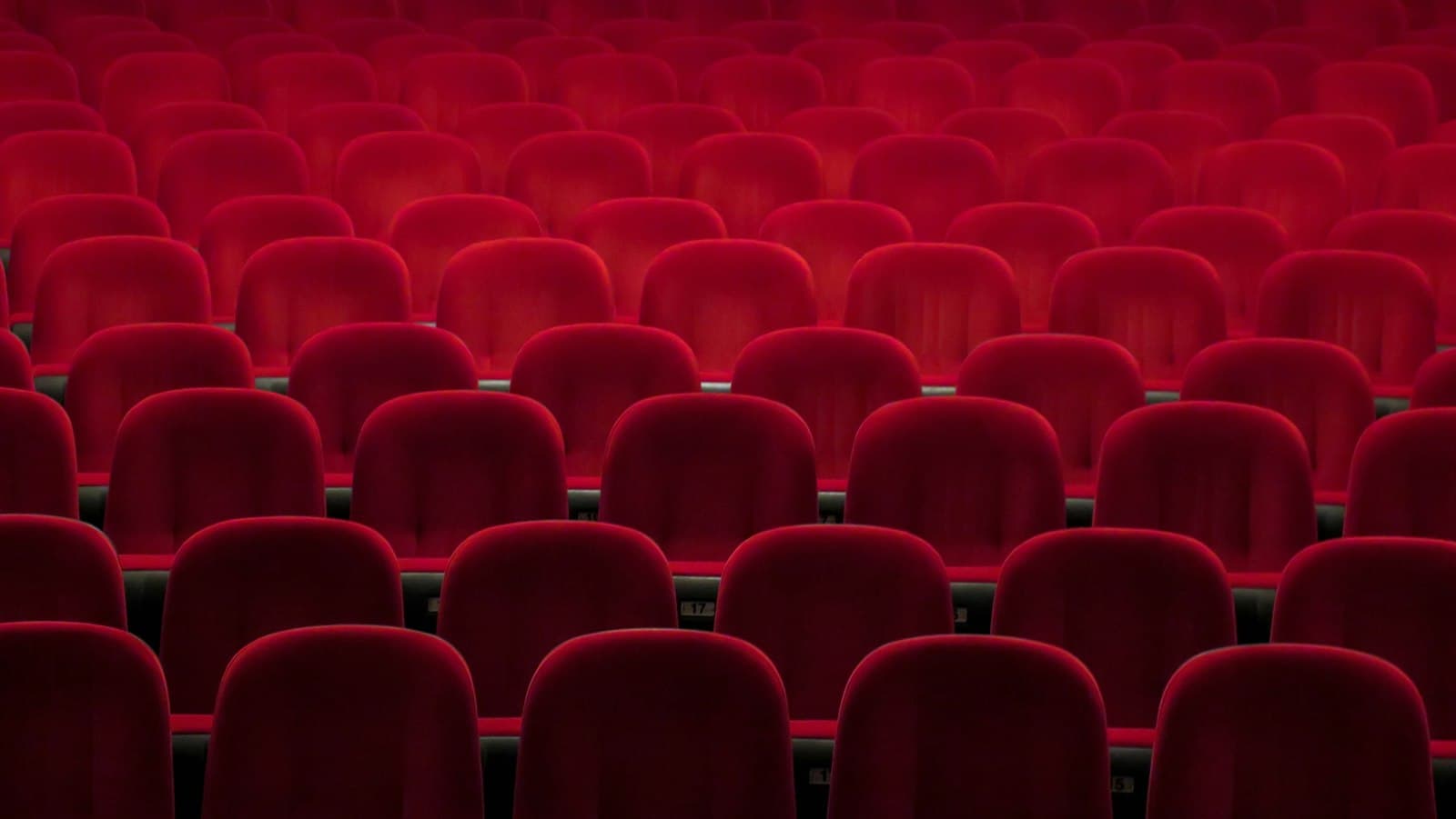 Rows of empty red cinema seats