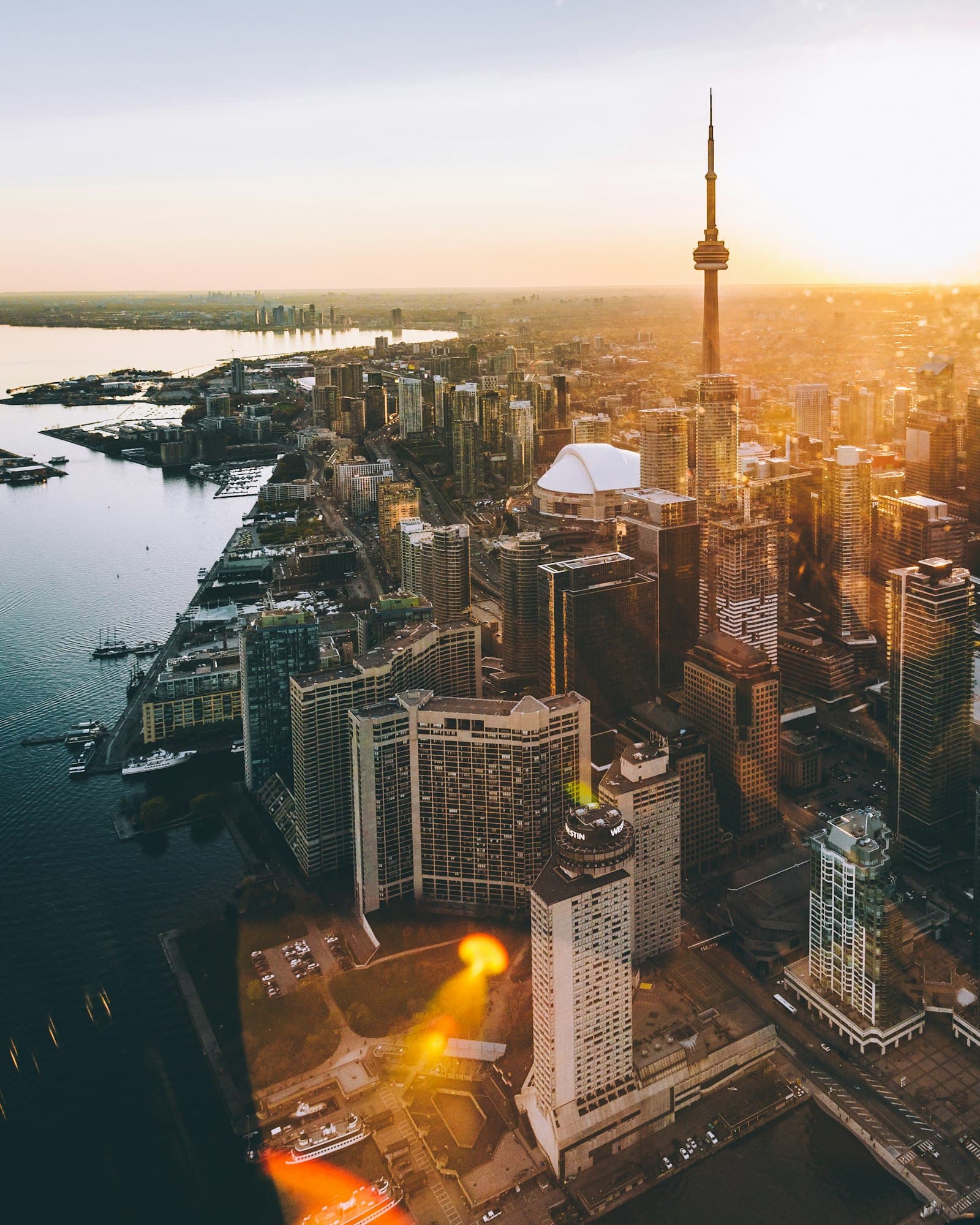 City skyline with a tall tower at sunset seen from above