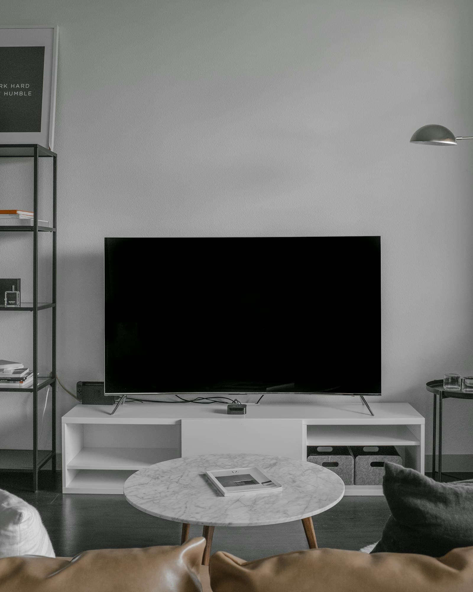 Television on a low cabinet in a bright, minimal living room